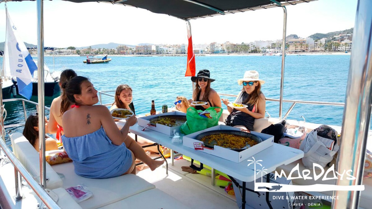 a group of people sitting in a boat on a body of water